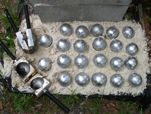 3lb cannonballs are dumped into soft sand to cool.