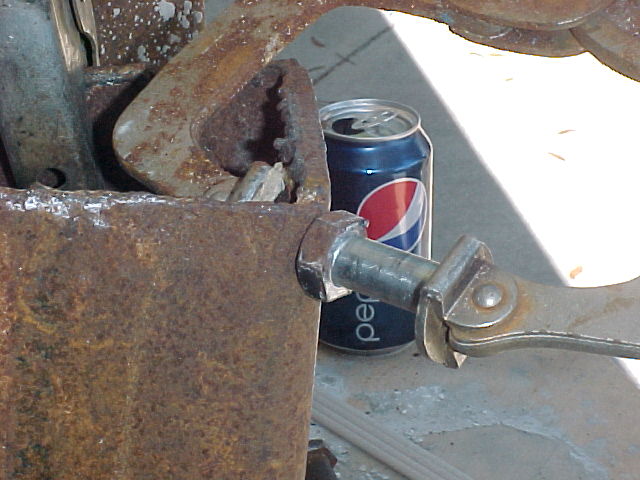 a clamp holds the cutoff bolts in place to be welded to crucible bodies